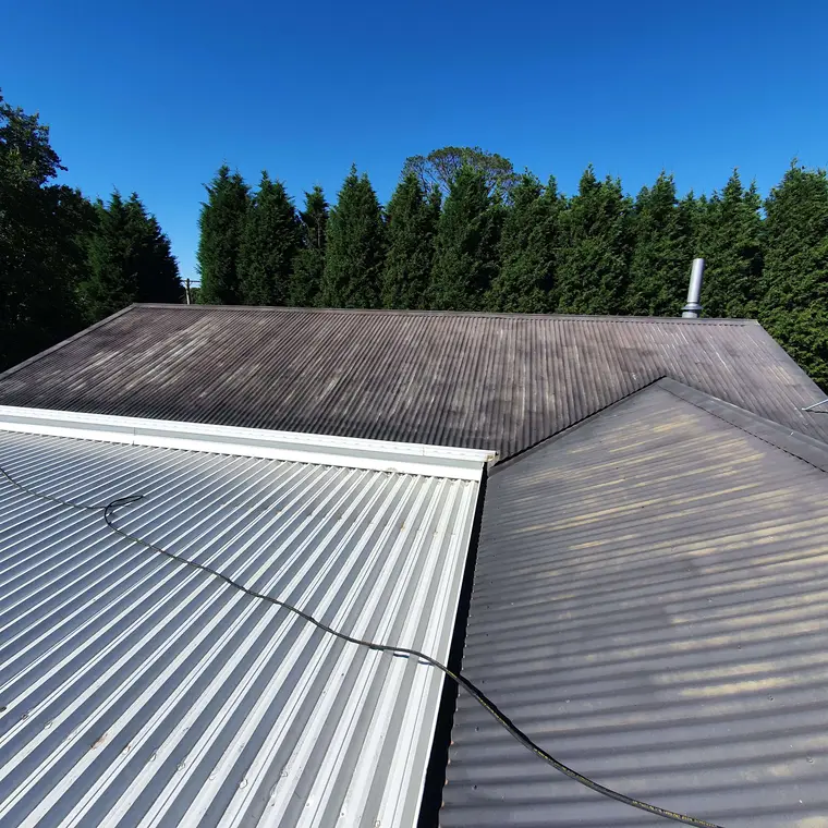 Dark corrugated residential roof before repainting