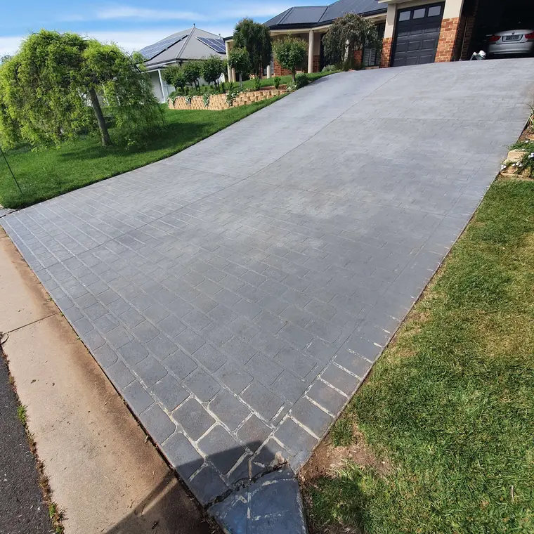 Faded concrete driveway before recoating