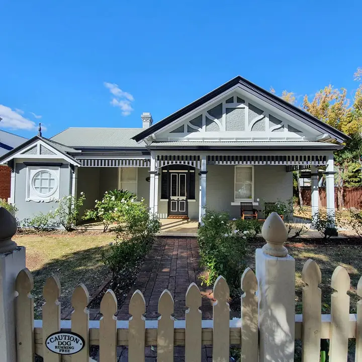 Heritage home after exterior repainting in grey, white and black