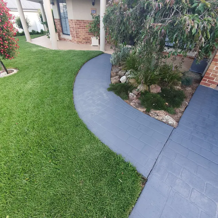 Curved concrete pathway after a fresh charcoal coating