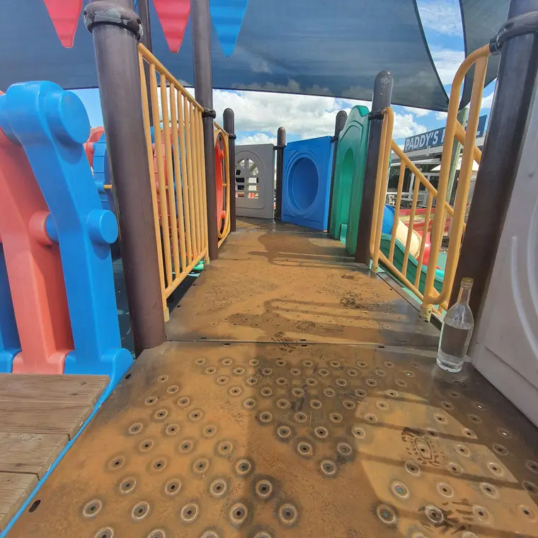 Weathered playground platform before commercial repainting