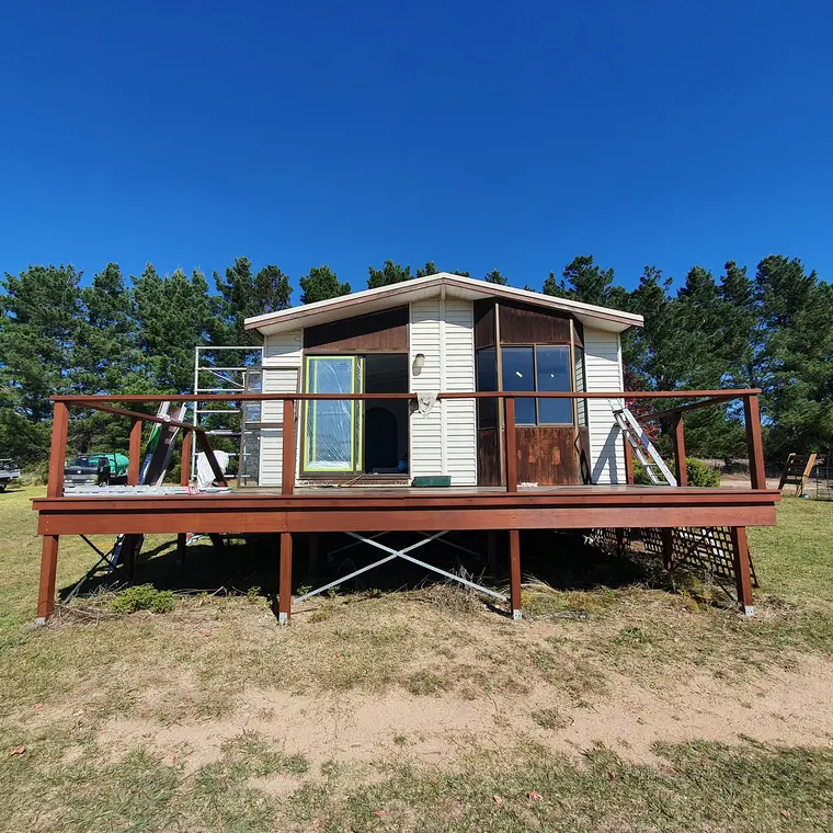 Small dwelling and deck before repainting