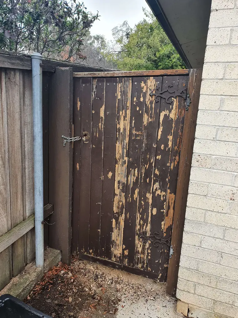 Weathered timber gate before restoration